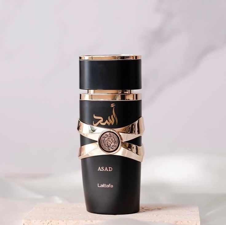 Lattafa Asad oil perfume bottle close-up – gold–black cap detail